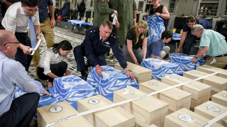 Crew and officials from the United Nations Command and U.S. Defense POW/MIA Accounting Agency (DPAA) secure UNC flags over transit cases of remains thought to be of U.S. soldiers killed in the 1950-53 Korean War, before returning them to the United States for further processing and identification, in Wonsan, North Korea, July 27, 2018.