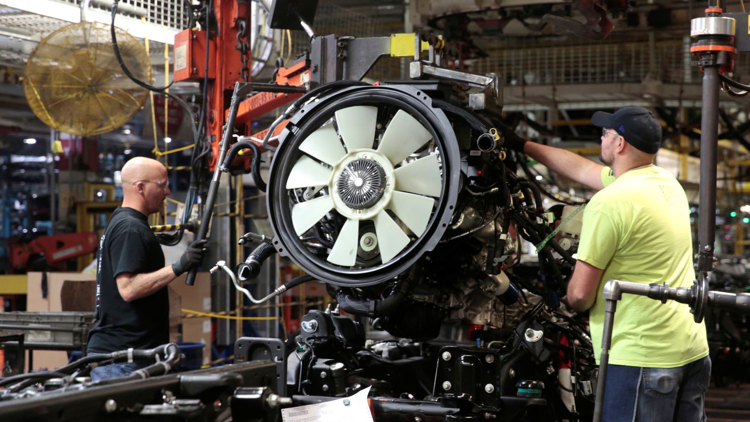 General Motors assembly workers attach the engine to the chassis of Chevrolet 2019 heavy-duty pickup trucks at General Motors Flint Assembly Plant in Flint, Michigan.