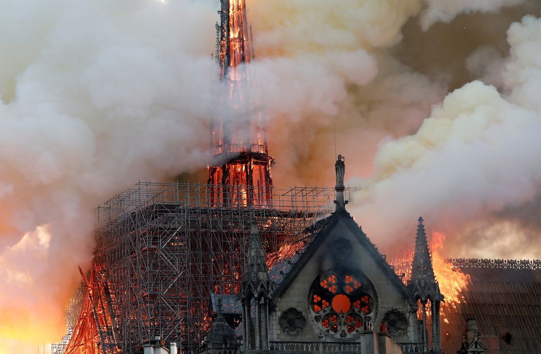 Huge plumes of smoke billow into the air as fire engulfs the spire of Notre Dame in Paris on April 15, 2019. It took firefighters nine hours to extinguish the blaze.