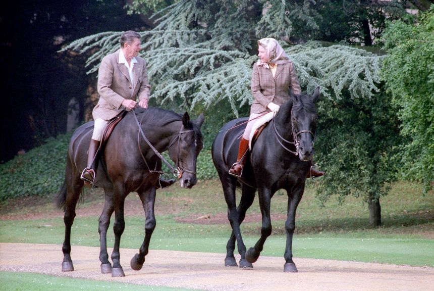 President Ronald Reagan rides horses with Queen Elizabeth II at Windsor Castle near London on June 8, 1982.