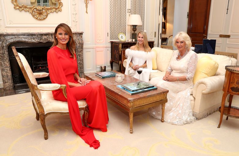 US first lady Melania Trump with Suzanne Ircha, wife of then-US Ambassador Woody Johnson, and Britain's then-Duchess of Cornwall at London's Winfield House in 2019.