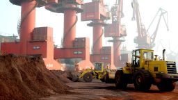 Workers transport soil containing rare earth elements for export at a port in Lianyungang.