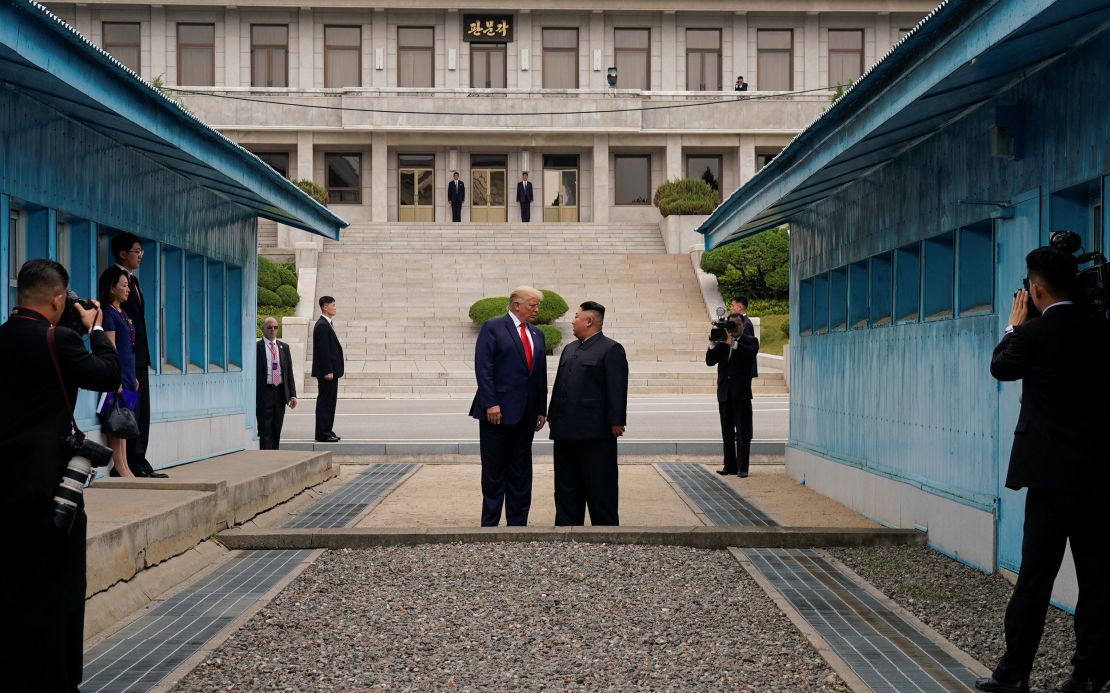 Then-President Trump and North Korean leader Kim Jong Un stand at a military demarcation line separating the two Koreas in Panmunjom, South Korea, on June 30, 2019.