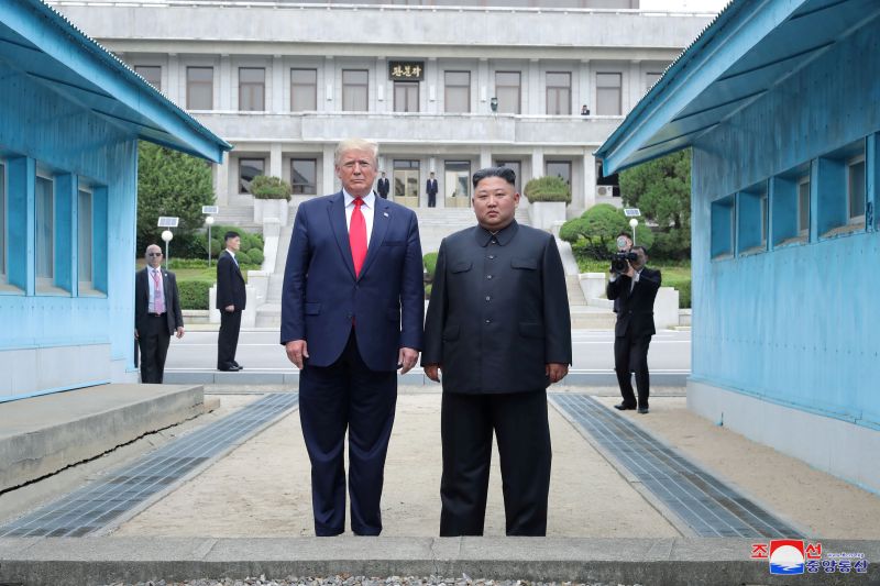 Then-President Trump and North Korean leader Kim Jong Un pose at a military demarcation line separating the two Koreas in Panmunjom, South Korea, on June 30, 2019.