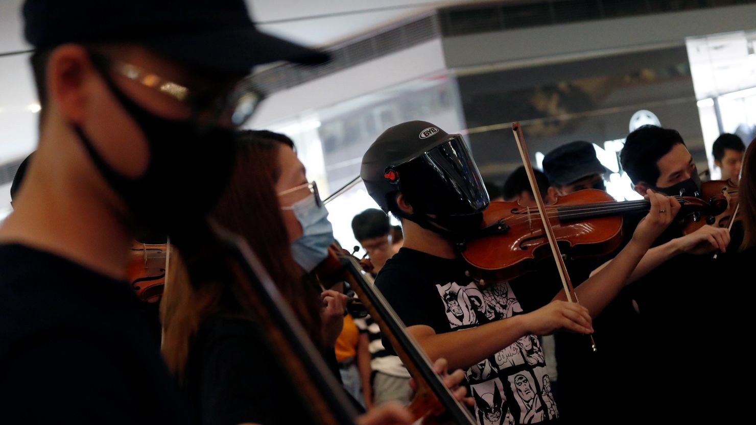 A group of musicians play 'Glory to Hong Kong,' during a flash mob protest at a shopping mall at Kowloon Tong, in Hong Kong, on September 18, 2019.
