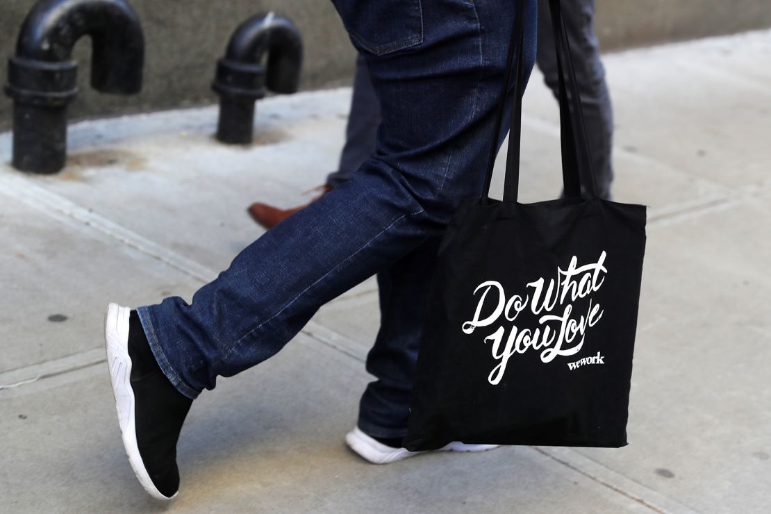 A laid-off WeWork employee carries a bag as he departs the WeWork corporate headquarters in Manhattan, New York, on November 21, 2019.