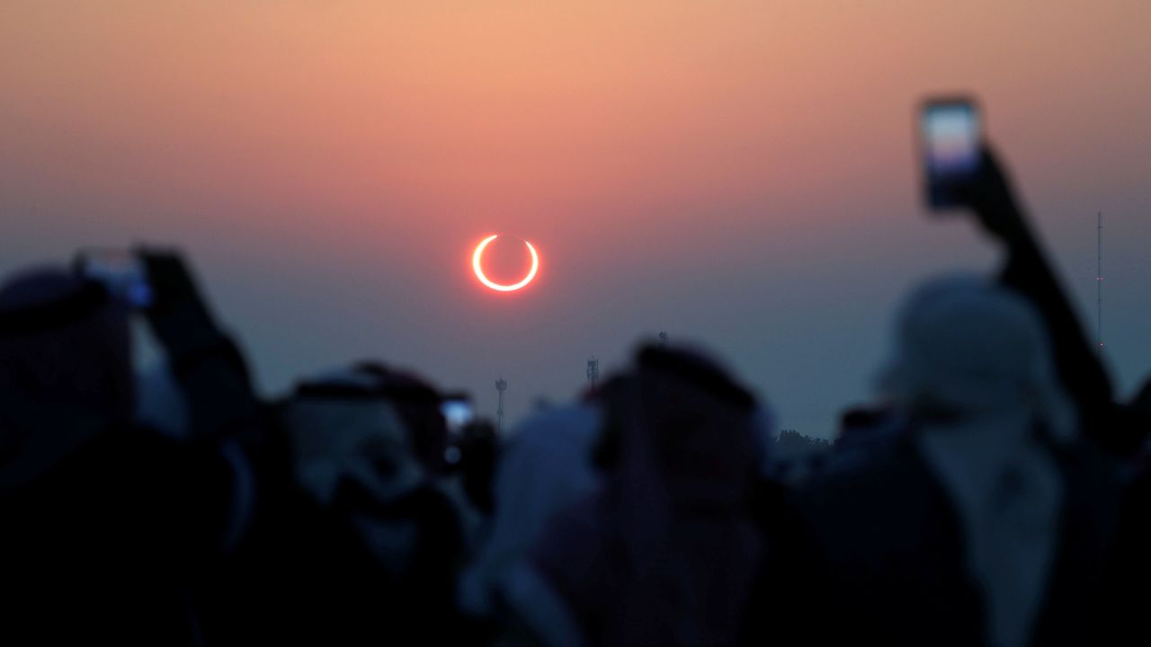 People take photos with their smartphones as they monitor the annular solar eclipse on Jabal Arba (Four Mountains) in Hofuf, in the Eastern Province of Saudi Arabia, December 26, 2019. REUTERS/Hamad I Mohammed