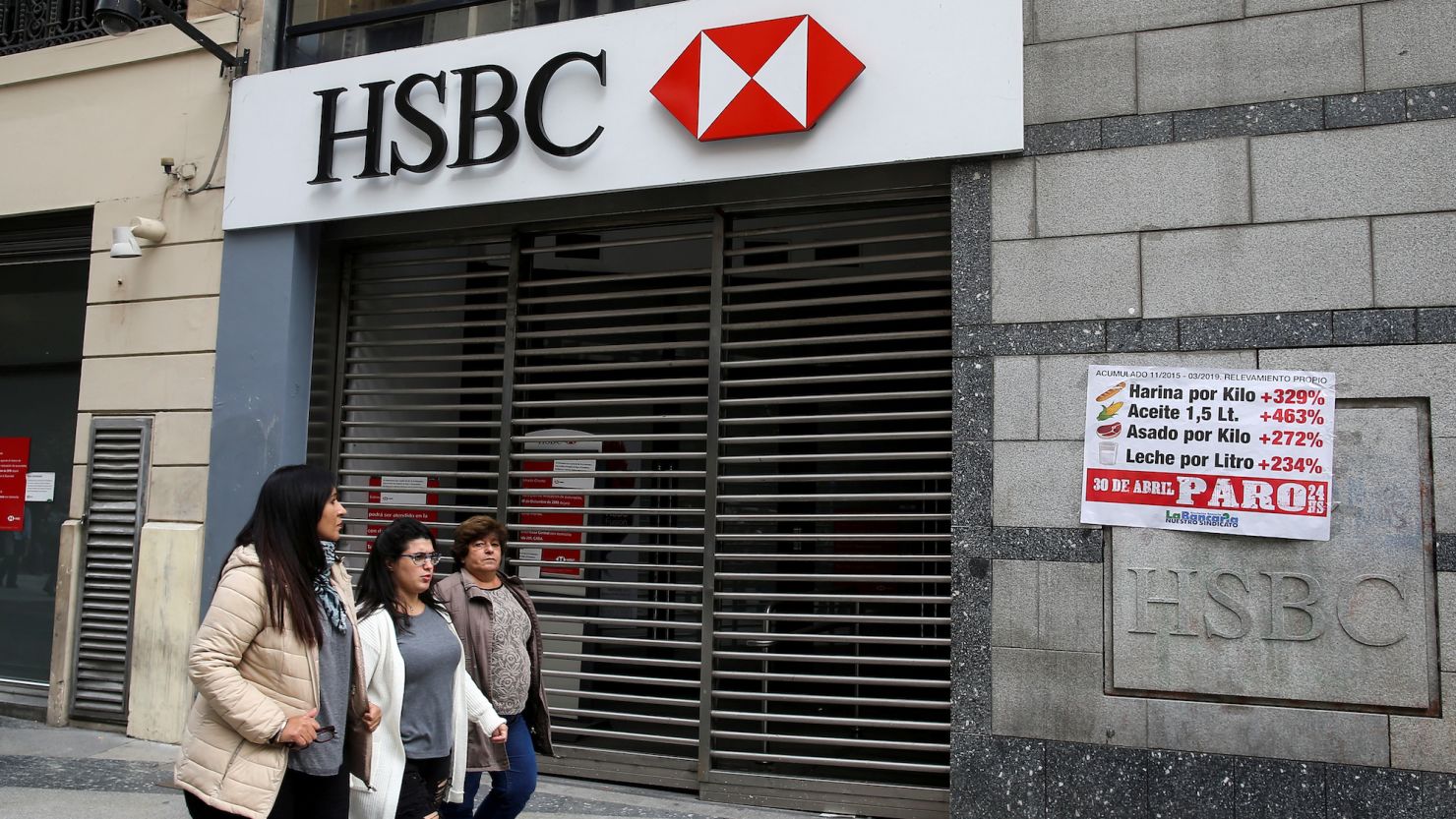 Pedestrians walk past a closed HSBC branch during a national strike in Buenos Aires, Argentina.
