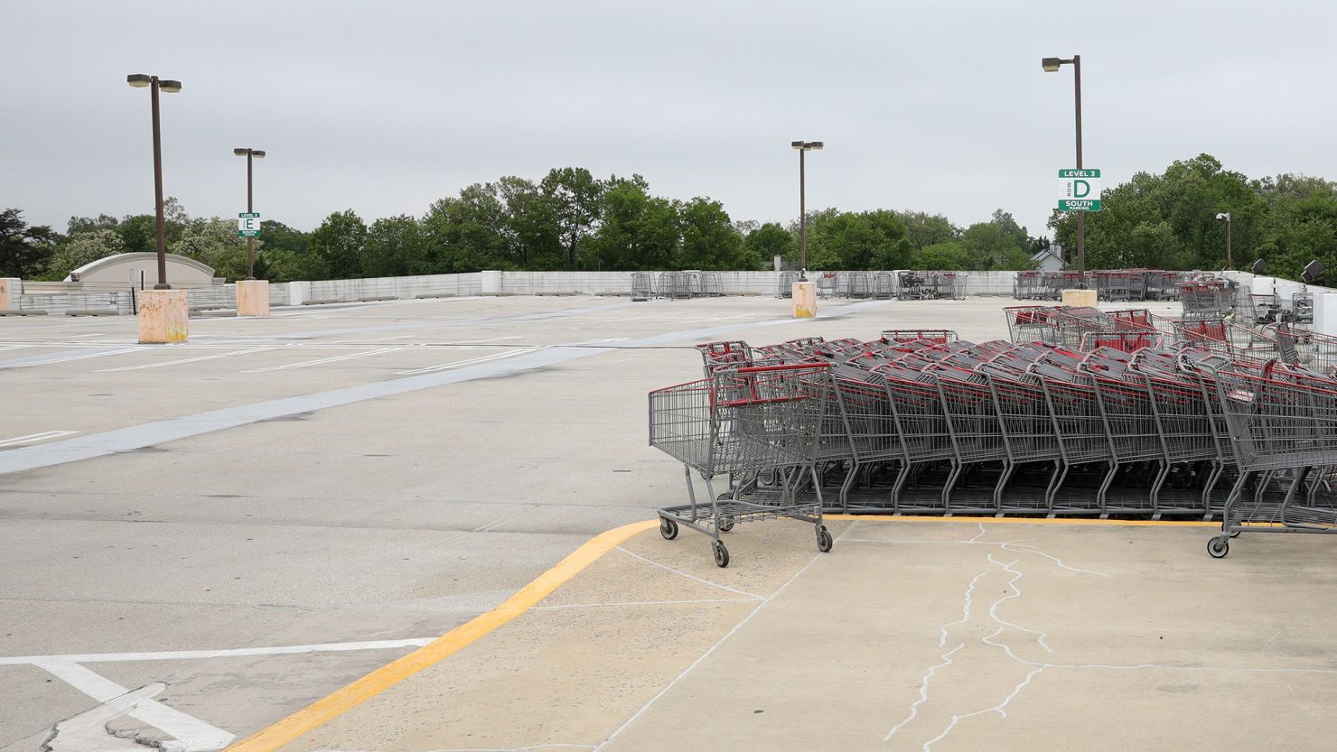 Shopping carts are seen stacked in a vacant parking lot outside of a Costco in Wheaton, Maryland, US, May 18, 2020.