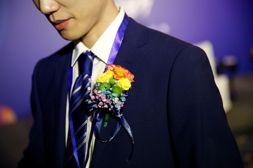 Staff at Blue City Holdings, which operates China's largest dating app for gay men, Blued, wears rainbow flower decorations in Beijing, China, on July 8, 2020.