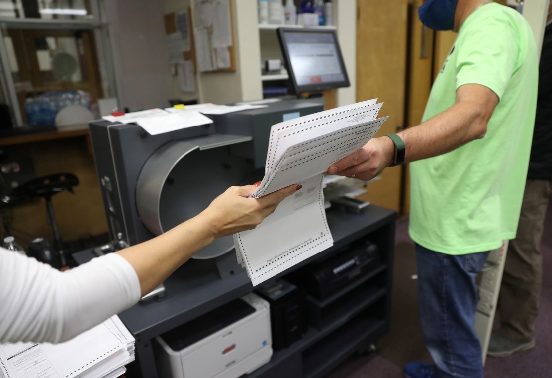 Election officials process absentee ballots at a central count facility in Kenosha, Wisconsin, on November 3, 2020.