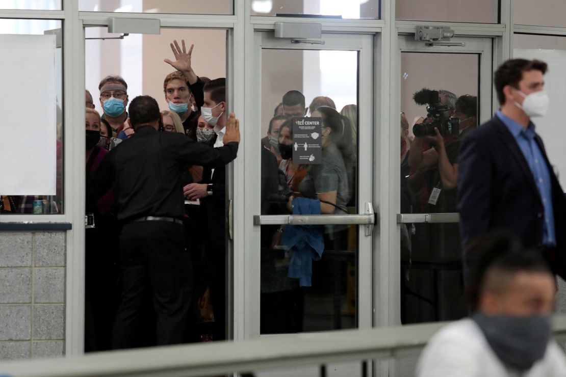 GOP poll challengers react after being asked to leave due to room capacity at the TCF Center in Detroit, Michigan, after Election Day, on November 4, 2020.