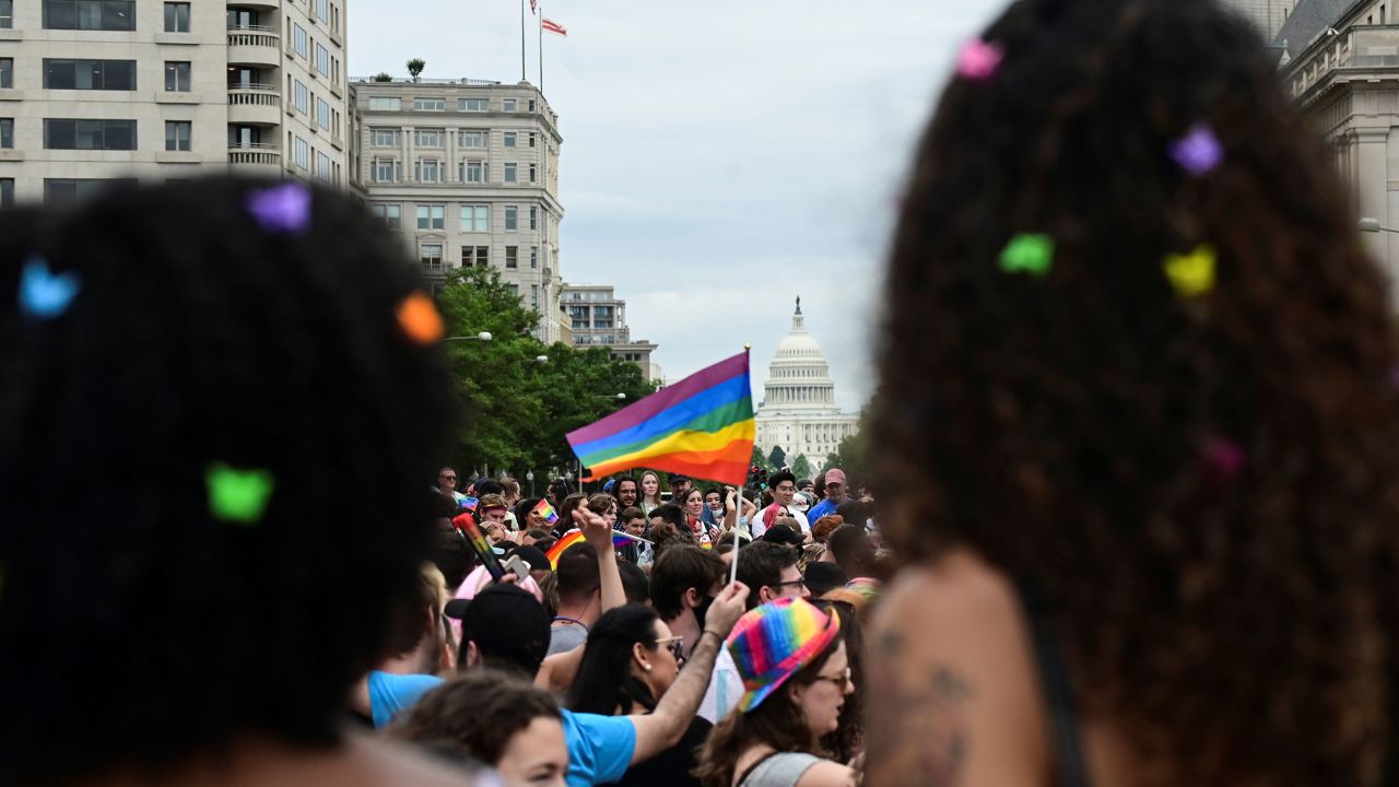 The US Capitol building is seen in the background as people attend a LGBTQ + Pride event in Washington, DC, in June 2021.