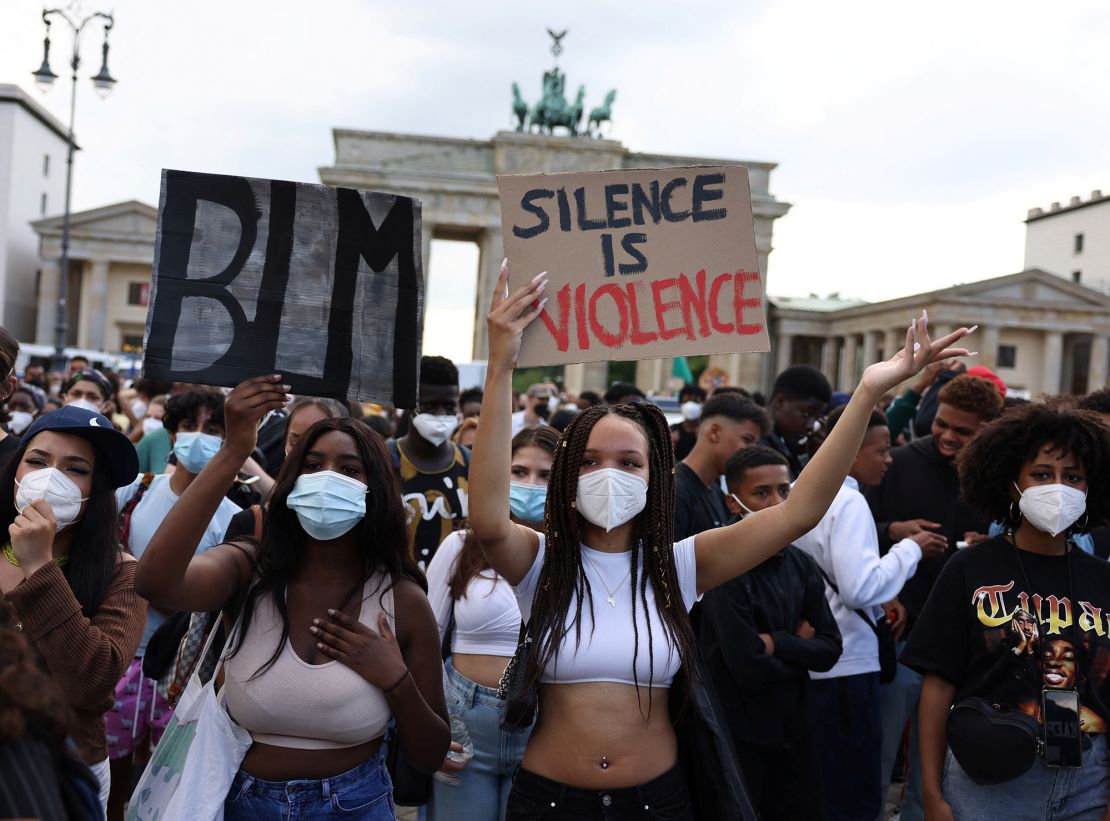 Demonstrators hold placards during a Black Lives Matter protest in front of Berlin's Brandenburg Gate in July 2021.