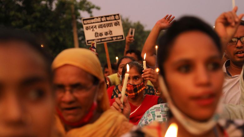 People attend a candlelit protest against rape and gender violence in New Delhi, India, August 8, 2021.