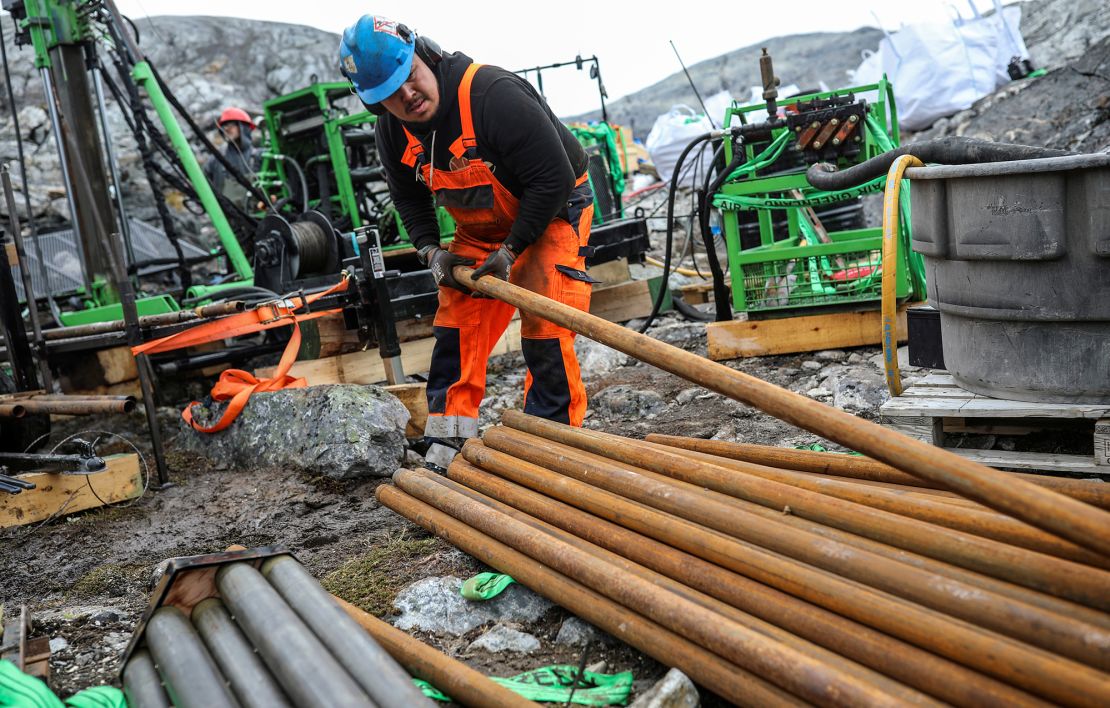 Workers drill at an exploration site of an anorthosite deposit close to the Qeqertarsuatsiaat fjord, Greenland in 2021.
