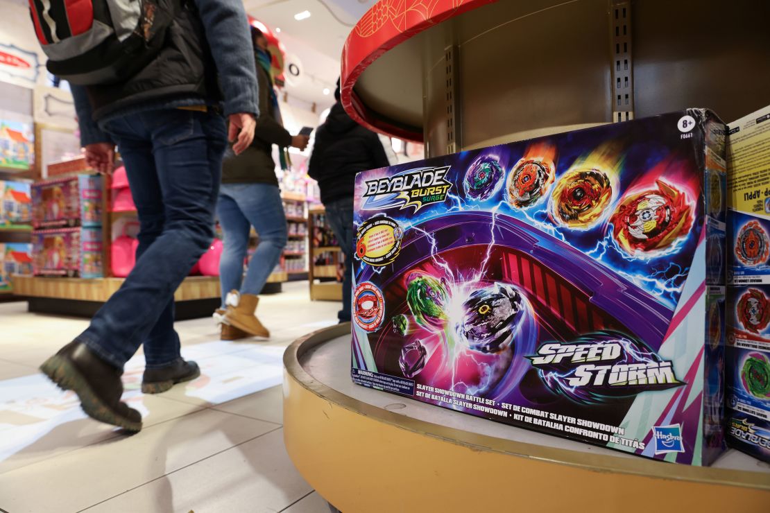 People walk past the Beyblade Burst Speedstorm by Hasbro in 2021.