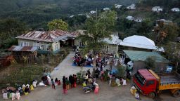 People who fled from Myanmar collect donated clothes at a temporary distribution centre at Farkawn village near the India-Myanmar border, in the northeastern state of Mizoram, India, November 20, 2021.