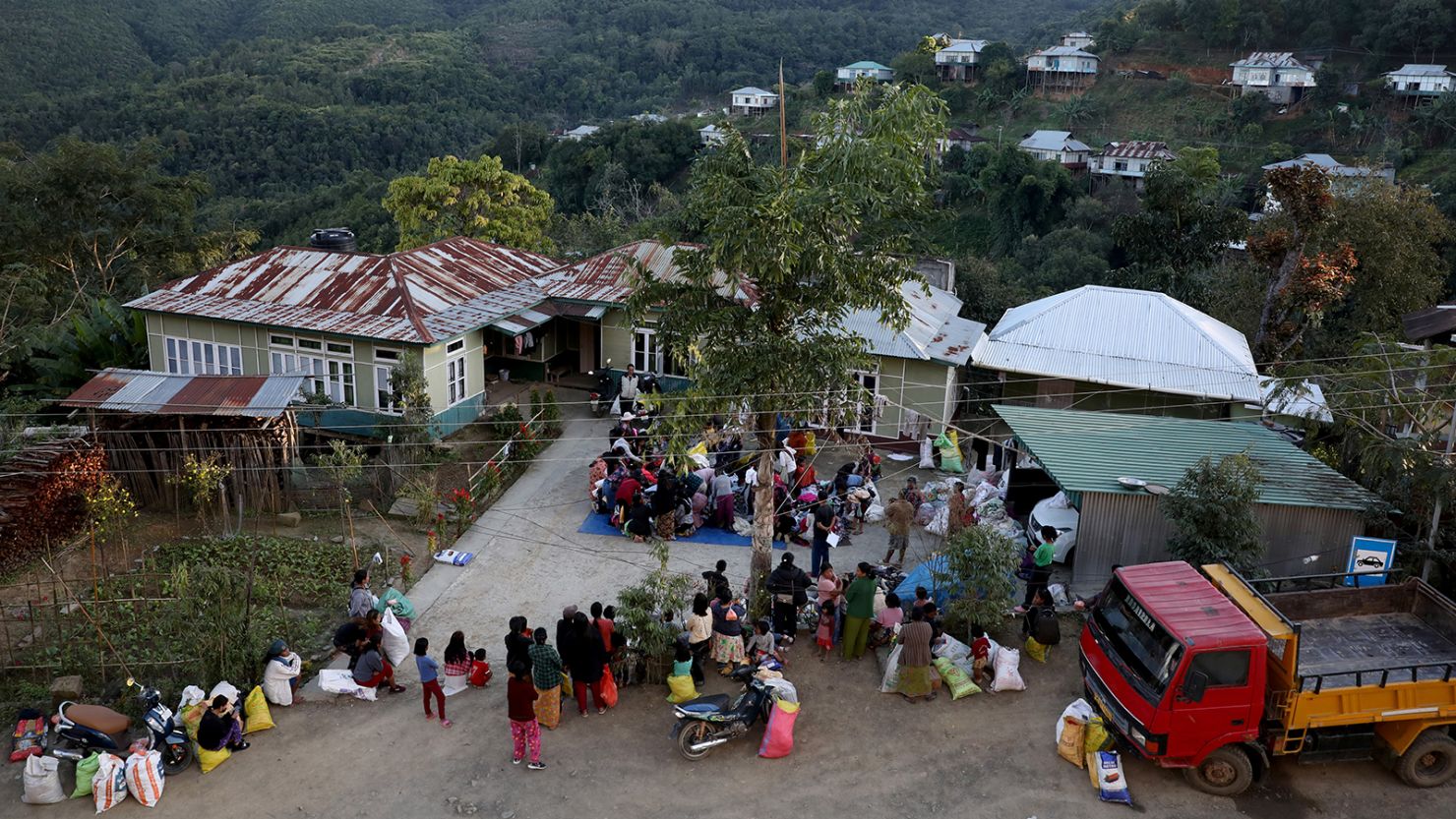 People who fled across the nearby Myanmar border collect donated clothes in India's northeastern state of Mizoram on November 20, 2021.