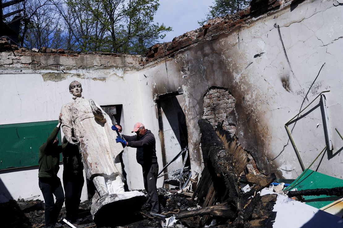 Workers remove the statue of Ukrainian philosopher Hryhorii Skovoroda after Russian bombing of the Hryhorii Skovoroda Literary Memorial Museum in May 2022.