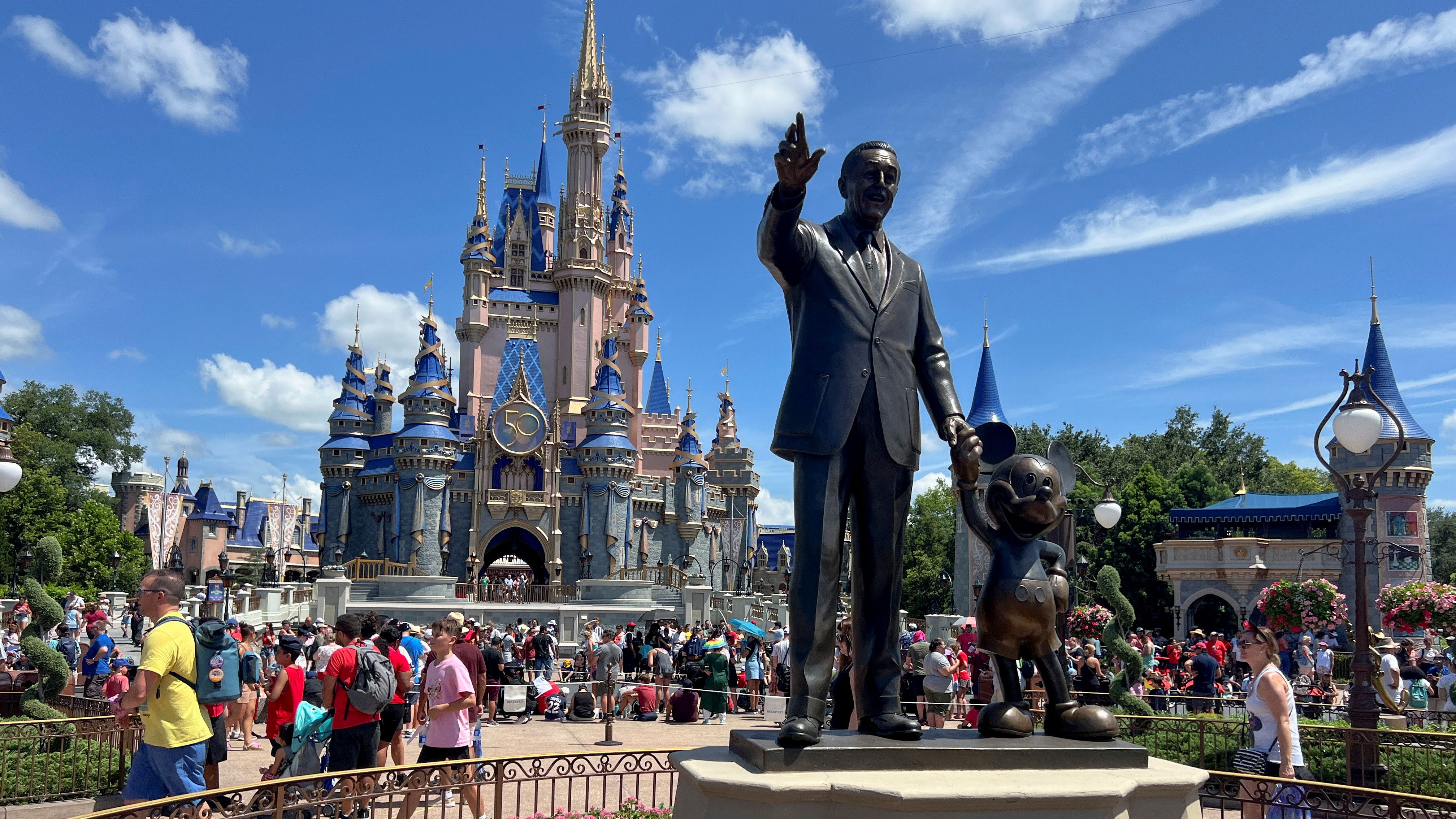 People gather at the Magic Kingdom theme park before the "Festival of Fantasy" parade at Walt Disney World in Orlando, Florida, U.S. July 30, 2022.