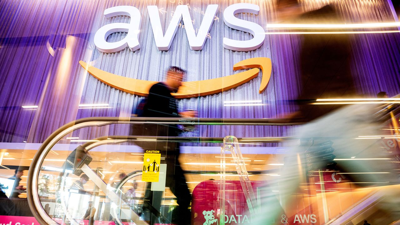 Attendees walk through AWS re:Invent 2022, a conference hosted by Amazon Web Services (AWS), in Las Vegas, Nevada, U.S., November 30, 2022.