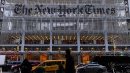 Pedestrians walk by the New York Times building in Manhattan, New York, in December 2022.