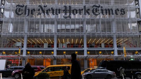 Pedestrians walk by the New York Times building in Manhattan, New York, in December 2022.