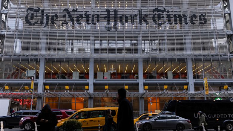 Pedestrians walk by the New York Times building in Manhattan, New York, in December 2022.