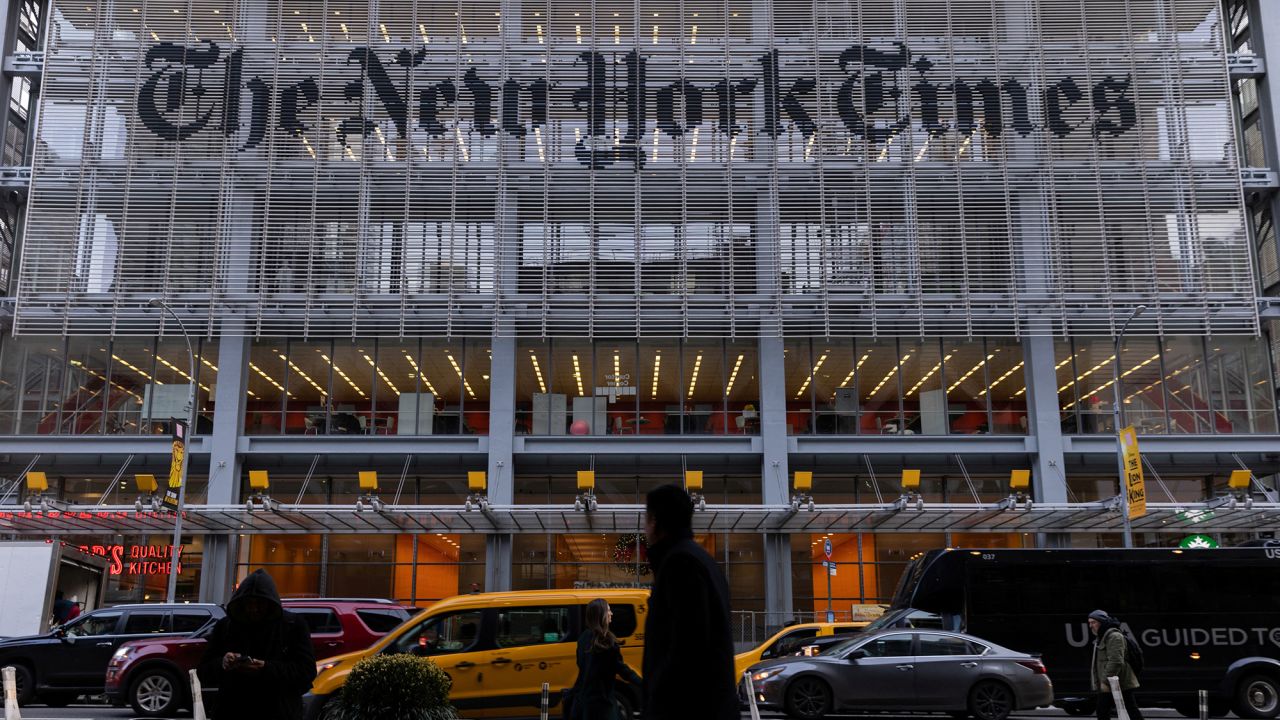 Pedestrians walk by the New York Times building in Manhattan, New York, in December 2022.