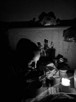 A woman shelters in a concrete basement without electricity and ventilation on March 9. - (Damage inflicted by airstrikes that began on March 8.)