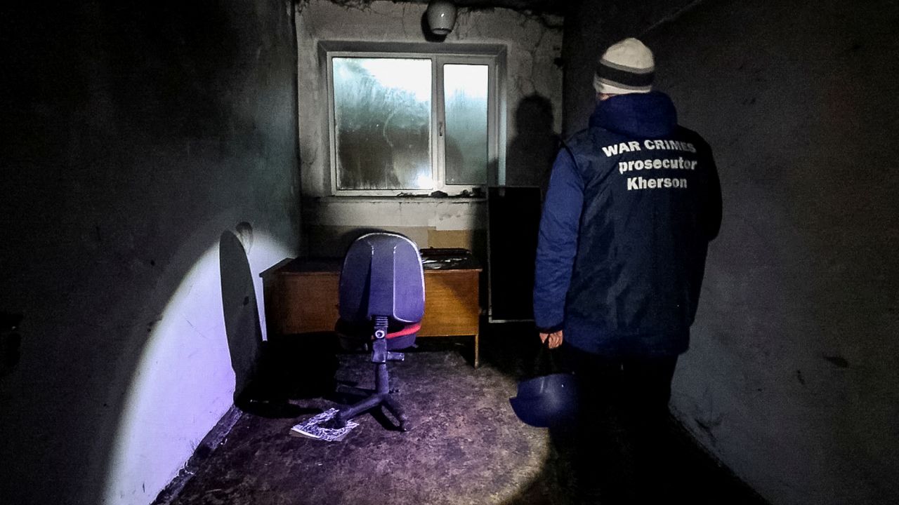 A war crime prosecutor inspects a basement of an office building, where prosecutor's office says 30 people were held for two months during the Russian occupation, amid Russia's attack on Ukraine, in Kherson, Ukraine December 20, 2022.  REUTERS/Anna Voitenko