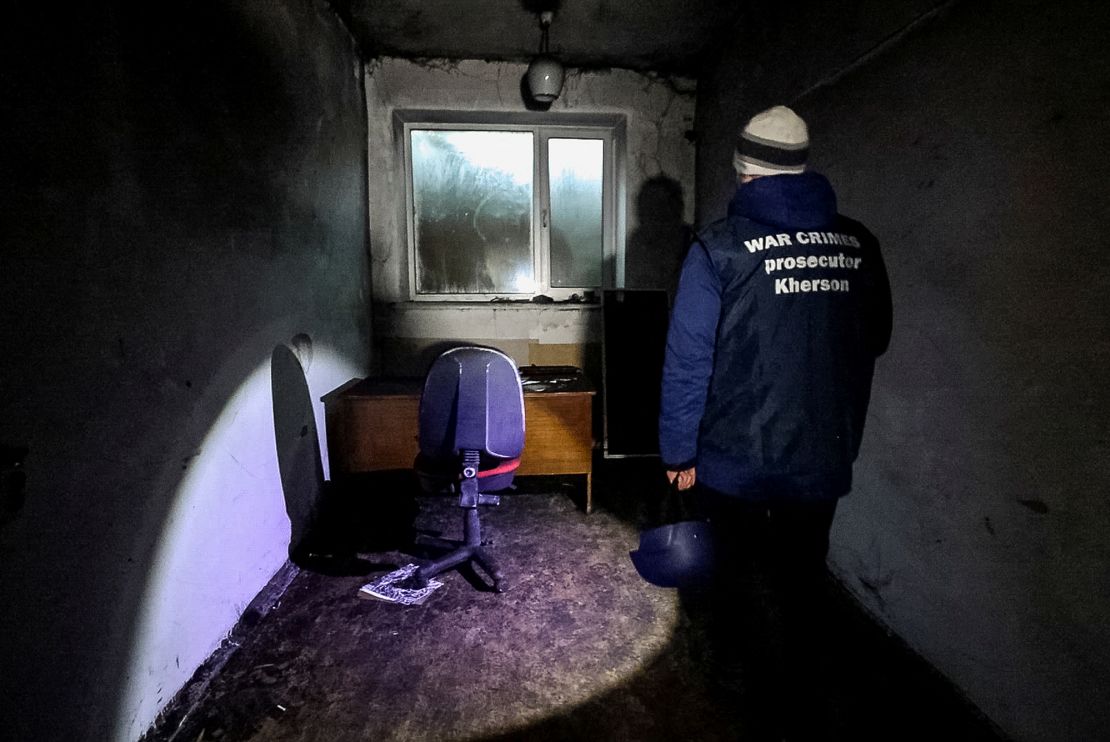 A war crime prosecutor inspects a basement of an office building in Kherson where some 30 people were held for two months during the Russian occupation.