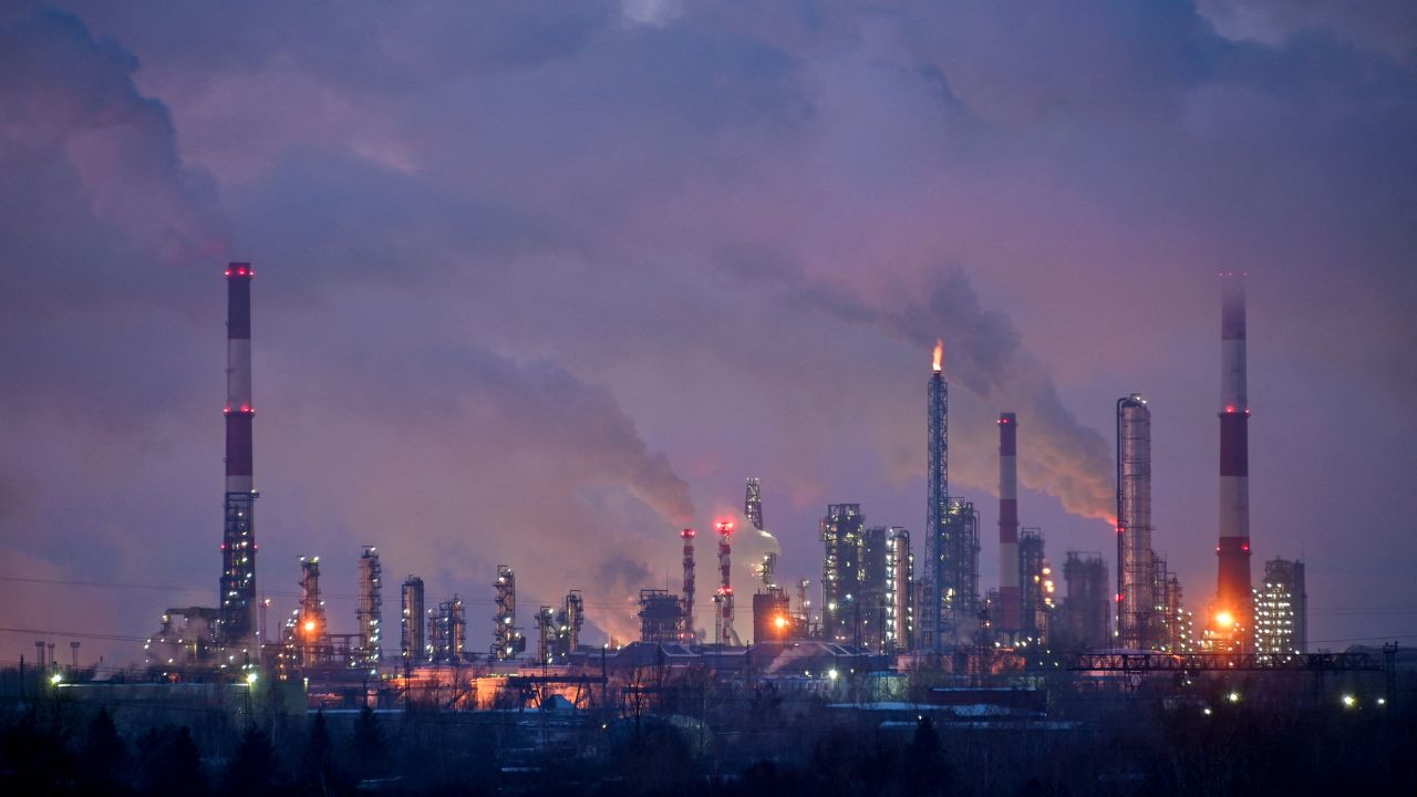 Flue gas and steam rise out of chimneys and smokestacks of an oil refinery during sunset on a frosty day in the Siberian city of Omsk, Russia, February 8, 2023.