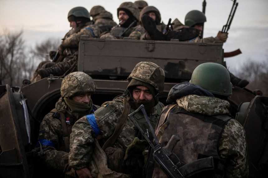 Ukrainian servicemen gather around an infantry fighting vehicle on a road outside Bakhmut in February 2023. The city was seized by Russia three months later.