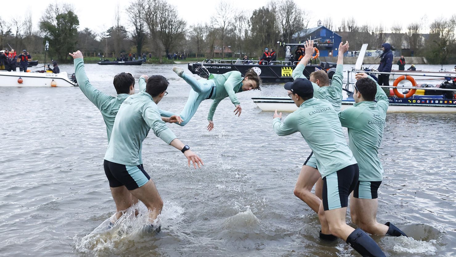 Cambridge coxswain Jasper Parish is thrown in the River Thames by teammates after winning the men's race last year.