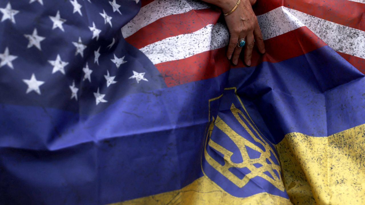 A woman holds a combination of the US and the Ukrainian flags, on Capitol Hill in Washington, DC, in April 2023.