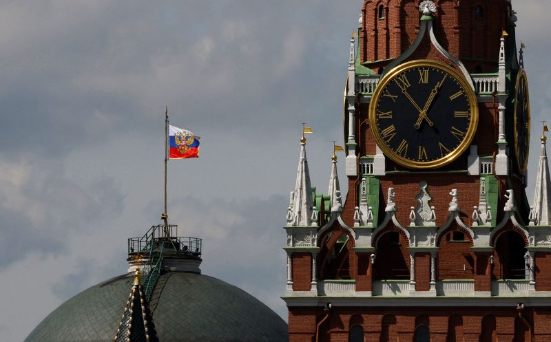 The Russian flag flies on the dome of the Kremlin Senate building behind Spasskaya Tower, while the roof shows what appears to be marks from the recent drone incident, in central Moscow, Russia, May 4, 2023. REUTERS/Stringer