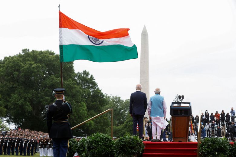 US President Joe Biden and India’s Prime Minister Narendra Modi looking out towards the Washington Monument with India's flag flying behind them in Washington on June 22, 2023.