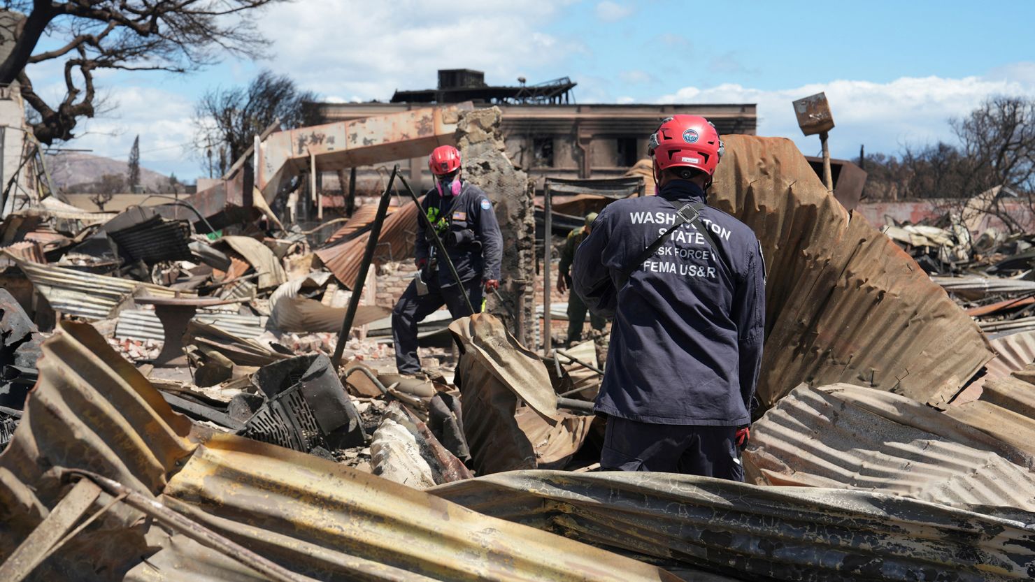 Members of FEMA Urban Search and Rescue teams Washington Task Force 1 and Nevada Task Force 1 searchi through neighborhoods destroyed by fire in the Maui city of Lahaina, Hawaii, on August 13, 2023.