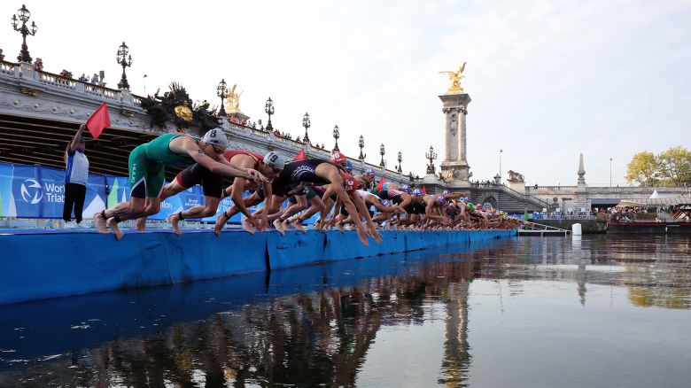 Athletes compete in the elite men triathlon test event in the river seine at Pont Alexandre III bridge on August 18, 2023.