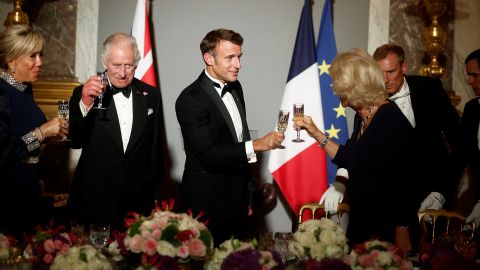 French President Emmanuel Macron, his wife Brigitte Macron, Britain's King Charles and Queen Camilla toast during a state dinner in the Hall of Mirrors at the Chateau de Versailles (Versailles Palace) in Versailles, near Paris in September 2023.