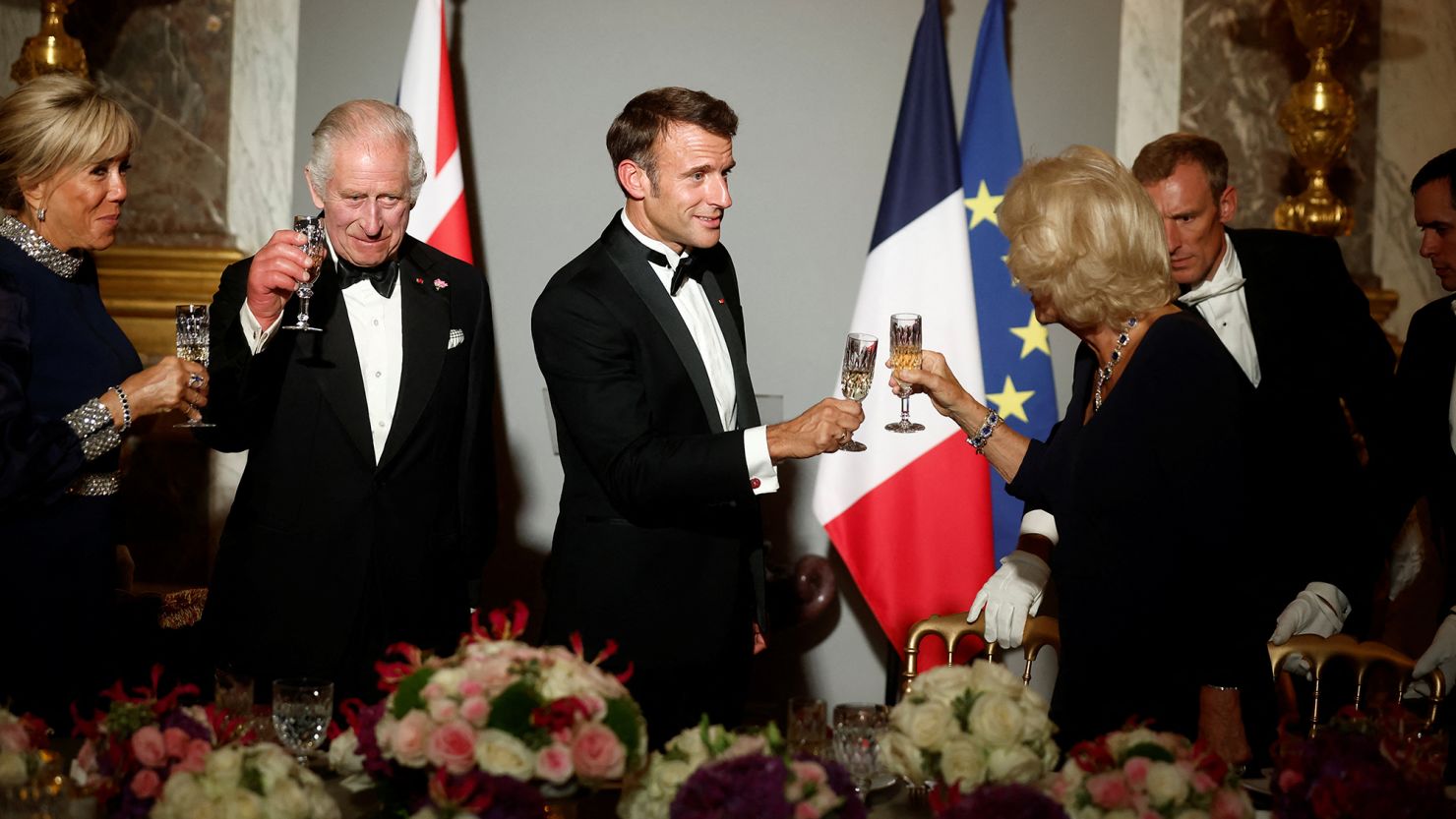 French President Emmanuel Macron, his wife Brigitte Macron, Britain's King Charles and Queen Camilla toast during a state dinner at the Chateau de Versailles near Paris in September 2023.