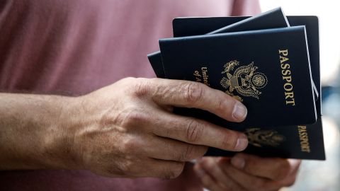 A man holds a stack of U.S. passports as U.S. nationals and their immediate family members wait before leaving Israel on a ship headed for Cyprus, amid the ongoing conflict between Israel and the Palestinian Islamist group Hamas, in Haifa, Israel, October 16, 2023. REUTERS/Shir Torem