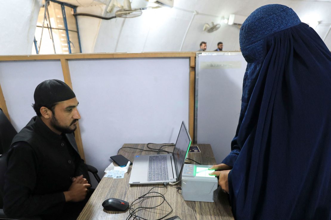 An Afghan refugee woman gives her fingerprints at the United Nations High Commissioner for Refugees repatriation center in Azakhel, Nowshera, Pakistan, on October 30, 2023.
