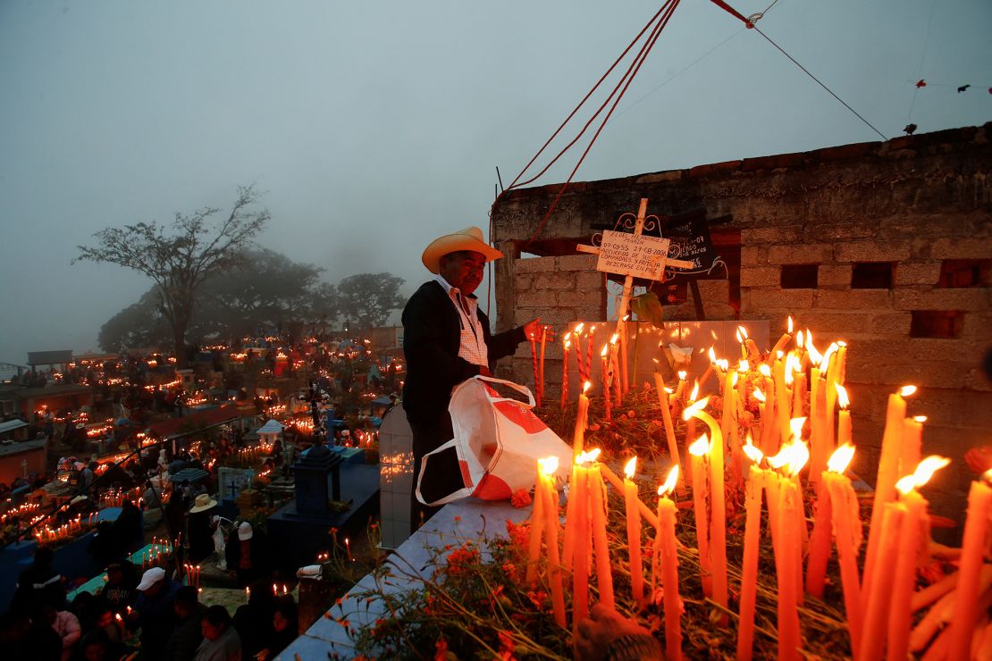 A man visits his deceased loved one's grave during the annual "Feast of the Ancestors" celebration, part of the Day of the Dead festivities, in Mazatlan Villa de Flores, Mexico on November 2, 2023.