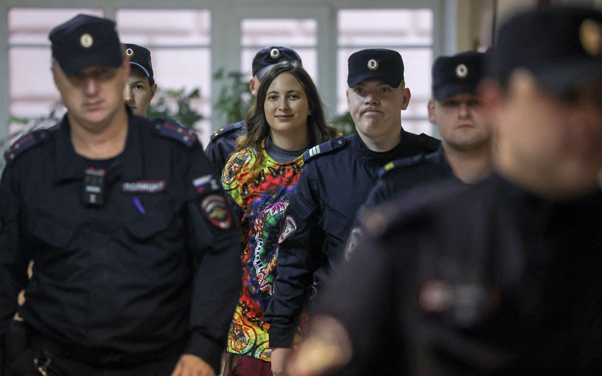 Artist Alexandra Skochilenko is escorted by a gaggle police officers before a court hearing in Saint Petersburg, Russia on November 14.