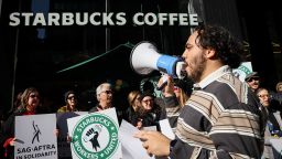 Members of the Starbucks Workers Union and other labor organization picket and hold a rally outside a company owned Starbucks store, during the coffee chain's Red Cup Day event in New York City, U.S., November 16, 2023.