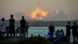 People watch as SpaceX's next-generation Starship spacecraft atop its powerful Super Heavy rocket lifts off from the company's Boca Chica launchpad on an uncrewed test flight, as seen from South Padre Island, near Brownsville, Texas, U.S. November 18, 2023. REUTERS/Go Nakamura     TPX IMAGES OF THE DAY     