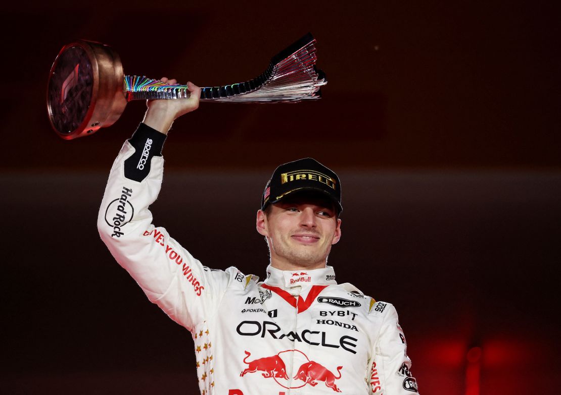 Max Verstappen celebrates with the trophy on the podium.